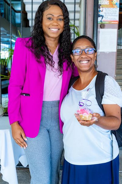 Dominica: Minister Denise Charles distributes pins and cupcakes to co-workers on Intl Women Day